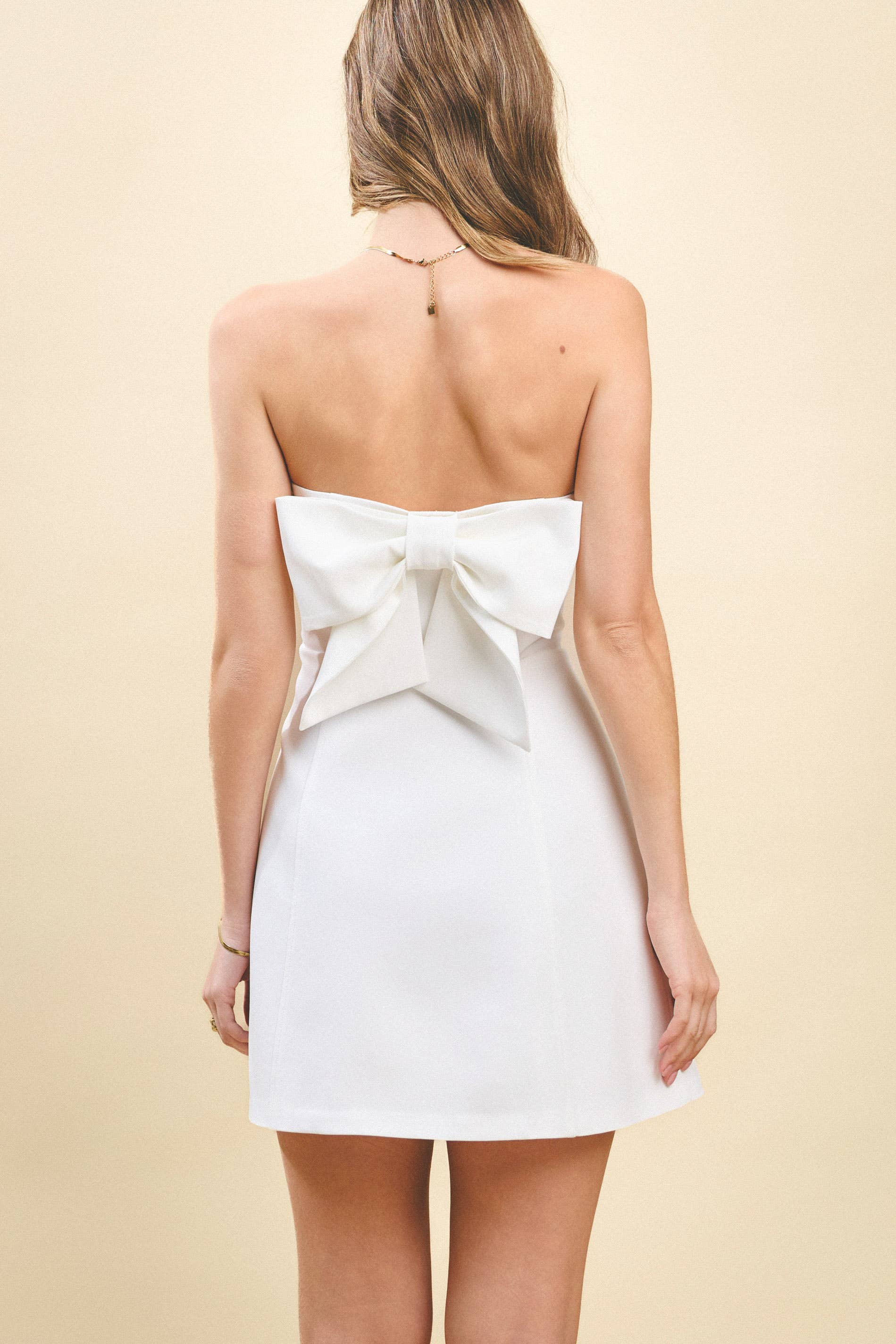Strapless Tailored Fit and Flare Bow Detail Dress. Rush