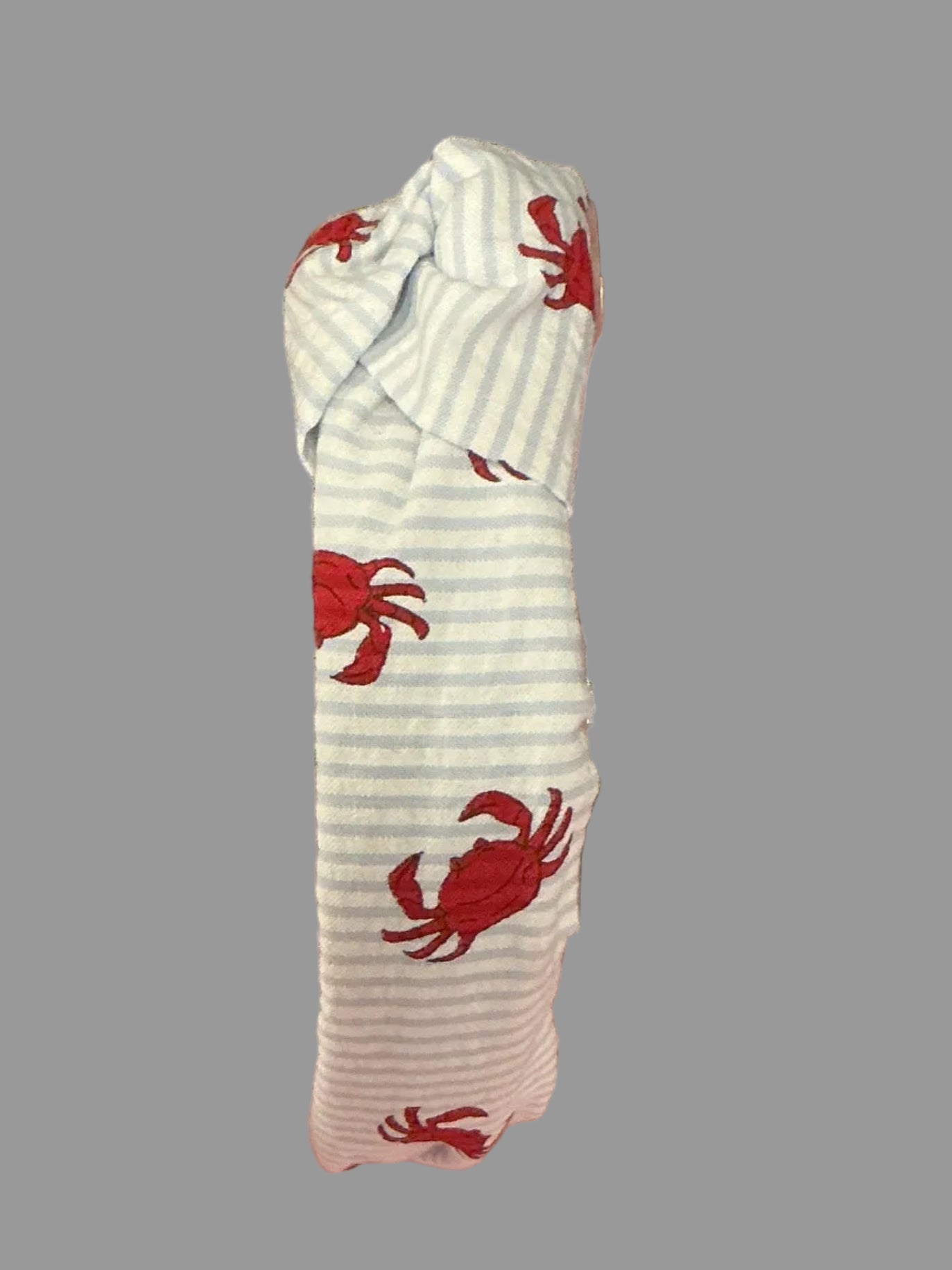 A clear acrylic pet step stool with fabric cushions featuring a red crab pattern on the top step and a red, green, and white striped pattern on the bottom step, set against a pink wall and black curtain backdrop.