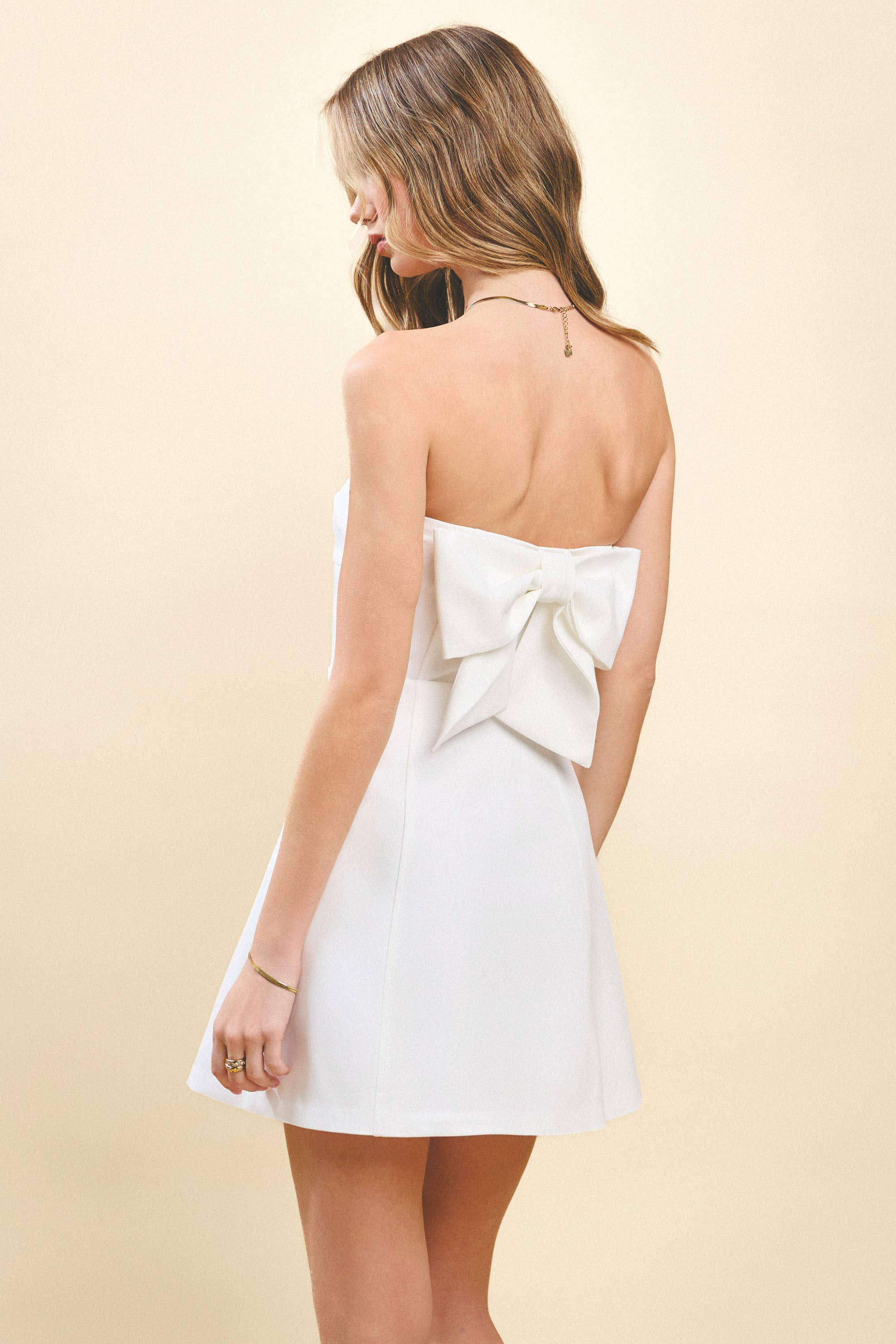 Strapless Tailored Fit and Flare Bow Detail Dress. Rush